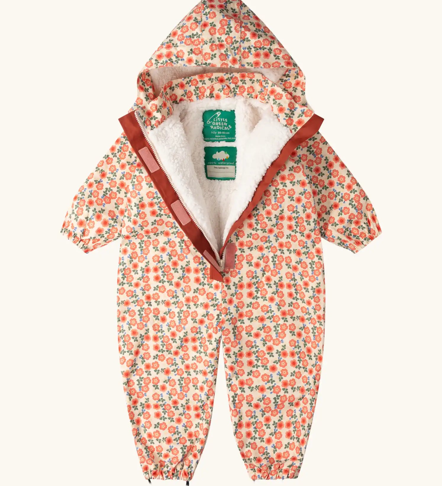 Little Green Radicals petals recycled waterproof winter suit with zip half open showing the fleece lining. Light background with pink repeat al over flower print. 