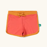 Little Green Radicals pink sunset recycled swim shorts with yellow gold waist and binding. 