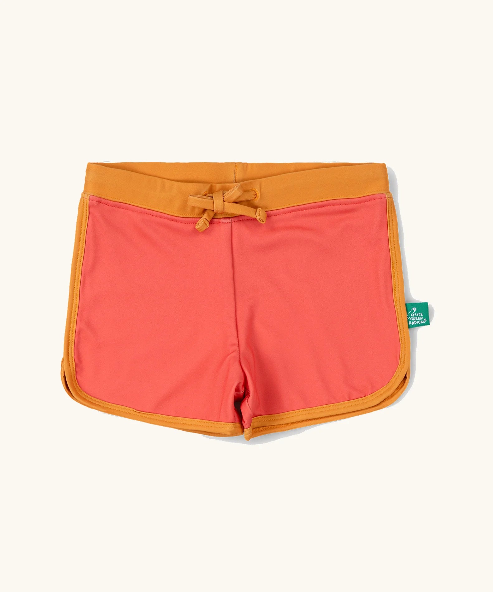 Little Green Radicals pink sunset recycled swim shorts with yellow gold waist and binding. 
