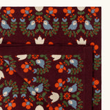 Close up of the Little Green Radicals purple folk birds knitted organic cotton baby blanket. 