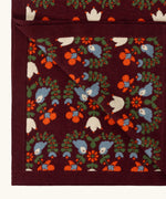 Close up of the Little Green Radicals purple folk birds knitted organic cotton baby blanket. 