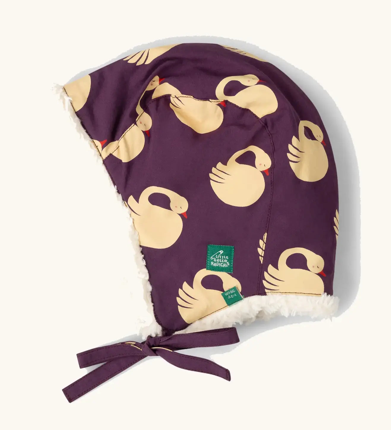 Little Green Radicals  sleeping swans print sherpa fleece lined purple hat. Purple organic cotton sherpa fleece lined flapper style hat with a sleeping swans print. 