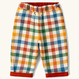 Little Green Radicals organic cotton reversible pull on trousers shown on the multi colour check brushed side.