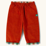 Little Green Radicals organic cotton reversible pull on trousers shown on the rusty orange cord side.