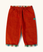 Little Green Radicals organic cotton reversible pull on trousers shown on the rusty orange cord side.