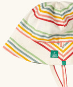 Close up of the Little Green Radicals cream rainbow stripe reversible organic cotton sunhat. Red, pink, yellow blue and green stripes on a cream background.