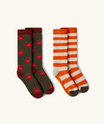 Little Green Radicals red apple organic cotton boot socks in a 2 pack. One dark green pair with red apple print, one white and orange stripes.