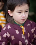 A close up of a child wearing the  Little Green Radicals Reversible Easy Rider Jacket on the Brown Bears print side. Little green Radicals have a wide range of organic cotton, Fairtrade children's clothing an outerwear available here at Babipur