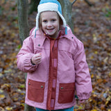 A child wearing the Little Green Radials sherpa fleece cosy hat in pale blue. This hat is a part of a wide range of organic cotton clothing and accessories for children available here at Babipur. 