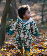 A child wearing the Little Green Radicals Organic Cotton Sherpa Fleece Snowsuit in the Hedgerow design.This organic cotton suit is a part of a wide range of organic cotton clothing for children available here at Babipur. 
