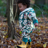 A child wearing the Little Green Radicals Organic Cotton Sherpa Fleece Snowsuit in the Hedgerow design.This organic cotton suit is a part of a wide range of organic cotton clothing for children available here at Babipur. 