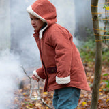 A child wearing the Little Green Radicals Kids Organic Sherpa Toasty Coat in a ginger colourway. This warm orange coloured jacket is part of a wide range of organic cotton clothing for children available here at Babipur. 