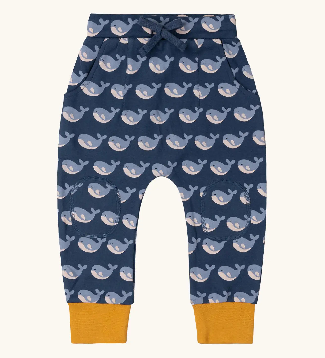 Little Green Radicals navy singing whales print comfy organic cotton joggers with yellow leg cuffs. 