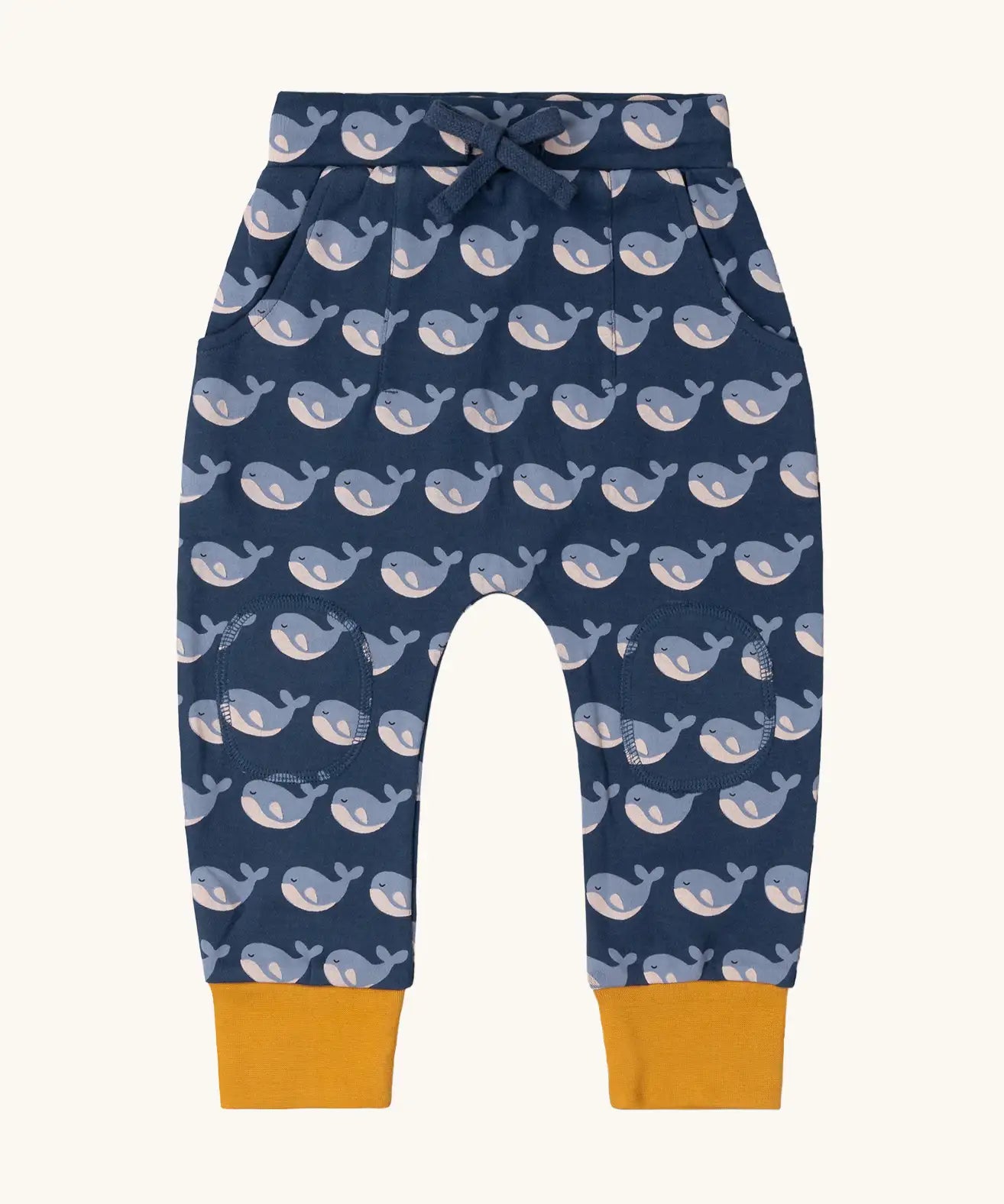 Little Green Radicals navy singing whales print comfy organic cotton joggers with yellow leg cuffs. 