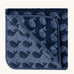 Little Green Radicals GOTS organic cotton hooded towel in navy blue with a repeating whale design folded into a square