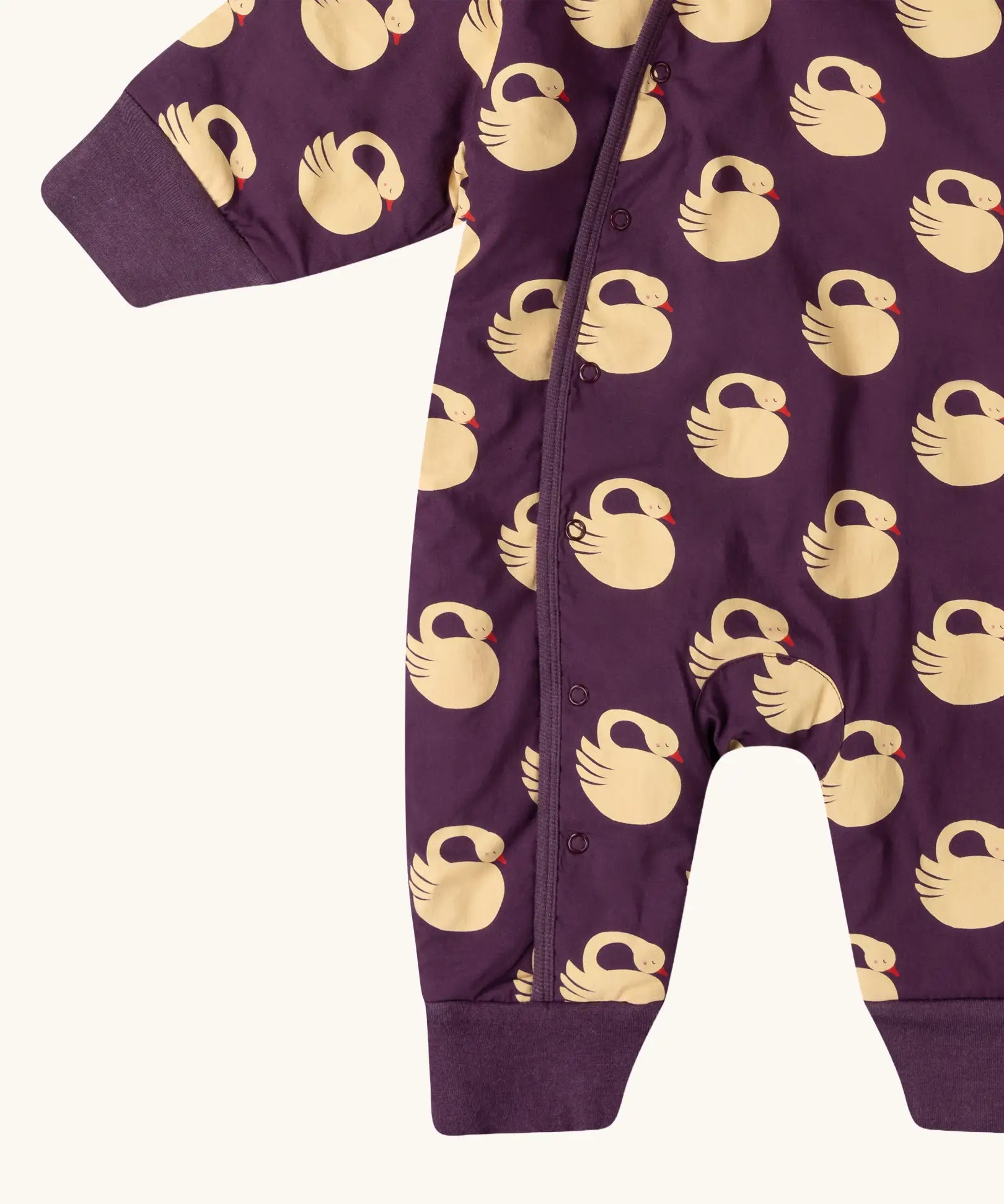 Close up of the leg cuffs on the Little Green Radicals purple sleeping swans print sherpa lined snowsuit.