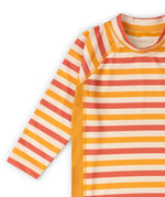 Close up of the striped front and arms on the Little Green Radicals sorbet striped UPF 50 sunsafe long sleeve rash vest. Yellow gold, cream and light red stripes.