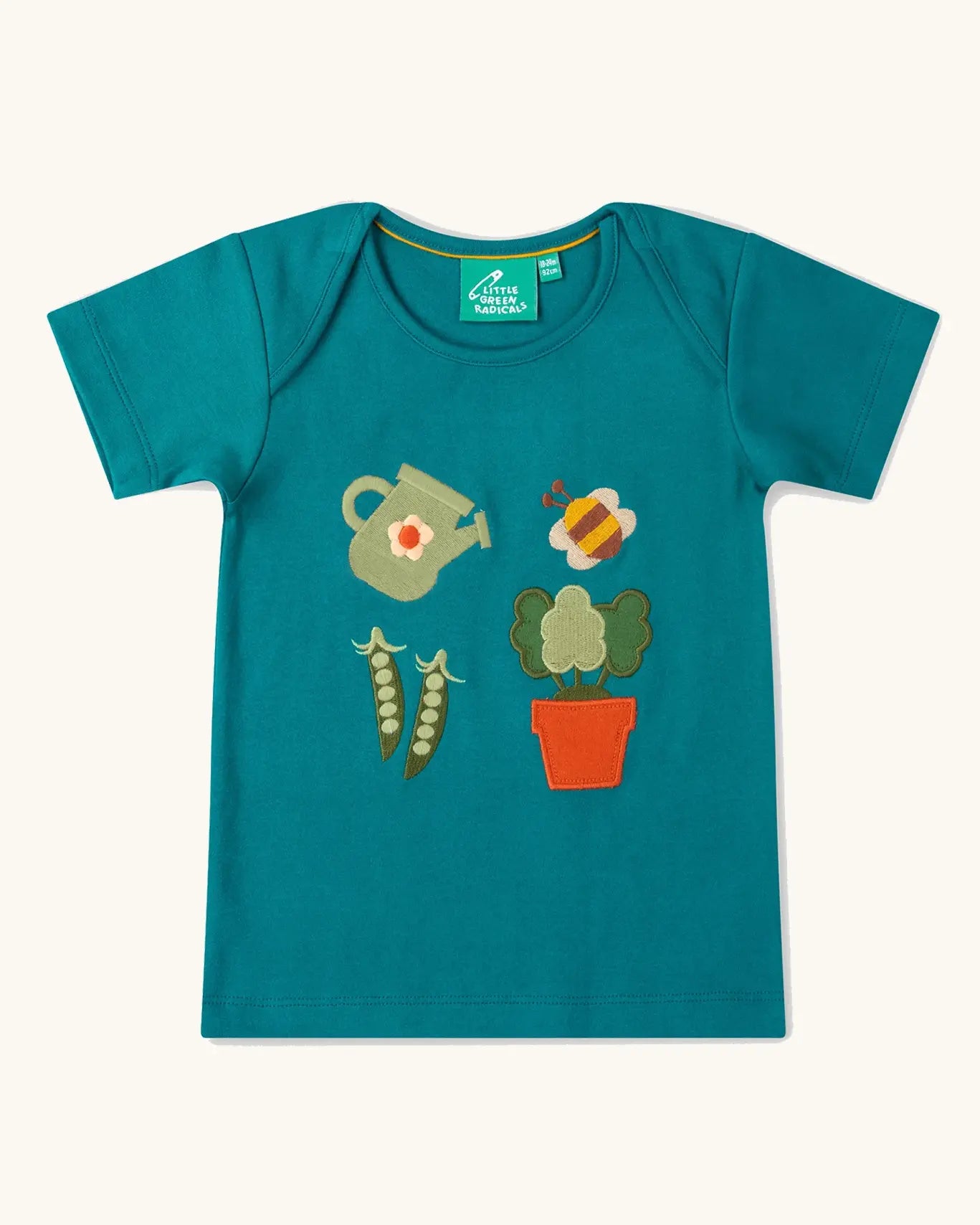 Little Green Radicals Spring garden embroidered organic cotton green t-shirt. Features 4 embroidered elements, a white watering can, peas in their pods, a bee and a potted plant.