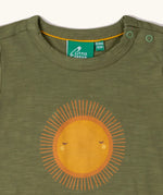 Close up of neck popper closure on the Little Green Radicals Summer rays sunshine short sleeve green popper organic-cotton t-shirt.