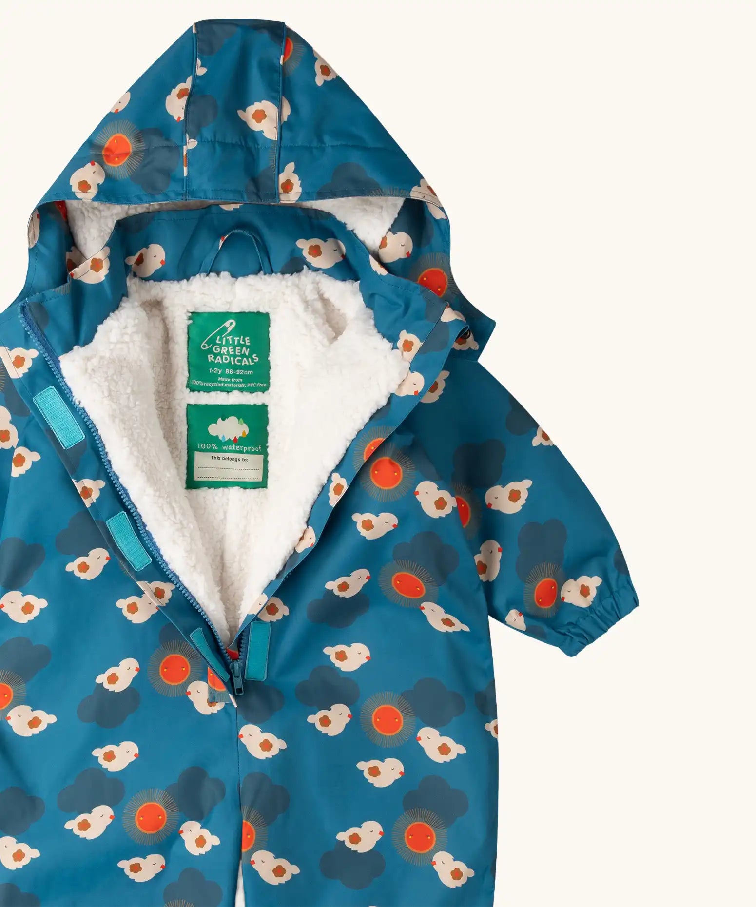 Close up of the Little Green Radicals sun birds recycled waterproof winter all in one suit unzipped showing the fleece lining. Blue background with white birds and orange sun. 