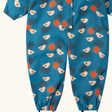 Close up of the foot straps on the Little Green Radicals sun birds recycled waterproof winter all in one suit. Blue background with white birds and orange sun. 