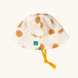 Little Green Radicals summer sun reversible cream sunhat shown on the repeat sunshine print side.