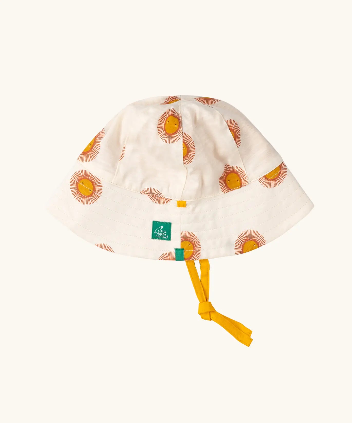 Little Green Radicals summer sun reversible cream sunhat shown on the repeat sunshine print side.
