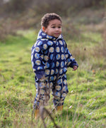 Young child wearing a Little Green Radicals sun folk blue sherpa fleece lined snowsuit.