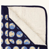 Close up of Little Green Radicals sun folk navy organic cotton sherpa hooded baby blanket . 