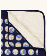 Close up of Little Green Radicals sun folk navy organic cotton sherpa hooded baby blanket . 