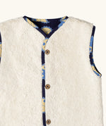 Close up of the sherpa fleece on the Little Green Radicals sun folk organic cotton sherpa fleece reversible gilet. 