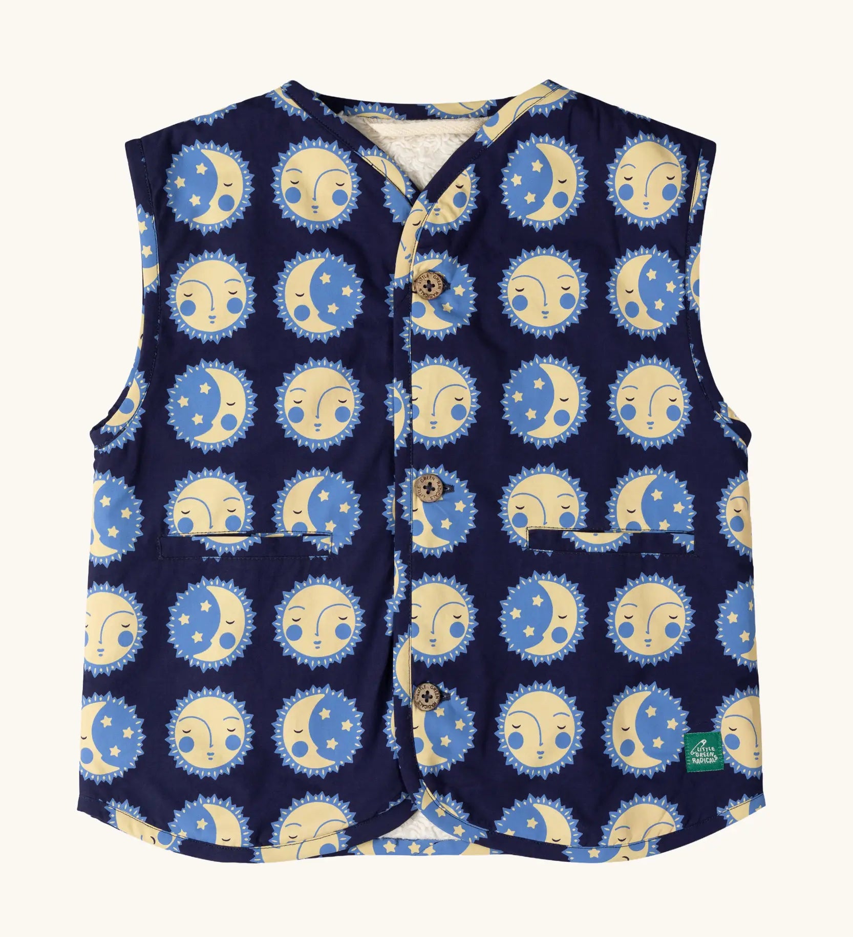 Little Green Radicals sun folk organic cotton sherpa fleece reversible gilet. Navy blue gilet with repeat sun and moon sun folk print on one side and sherpa fleece on the other. 