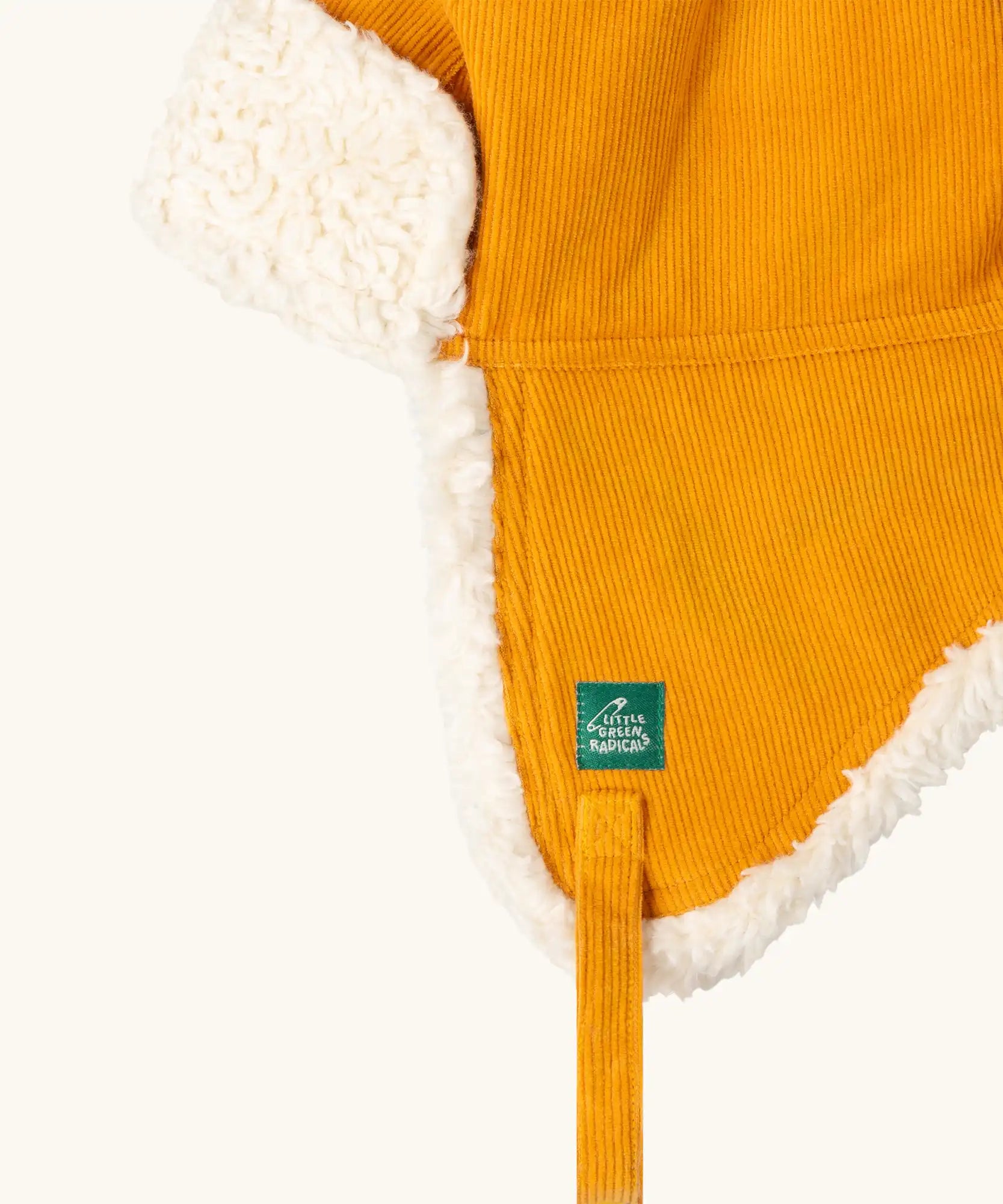 Close up of the Little Green Radicals sherpa fleece lined yellow gold corduroy cosy hat.