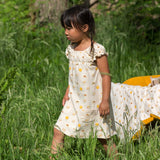 A child wearing the Little Green Radicals Sunshine & Rainbows Pocket Playdays Dress. Little green Radicals have a wide range of organic cotton, Fairtrade children's clothing and outerwear available here at Babipur.