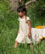 A child wearing the Little Green Radicals Sunshine & Rainbows Pocket Playdays Dress. Little green Radicals have a wide range of organic cotton, Fairtrade children's clothing and outerwear available here at Babipur.