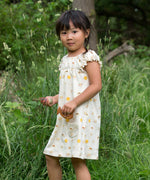 A child wearing the Little Green Radicals Sunshine & Rainbows Pocket Playdays Dress. Little green Radicals have a wide range of organic cotton, Fairtrade children's clothing and outerwear available here at Babipur.