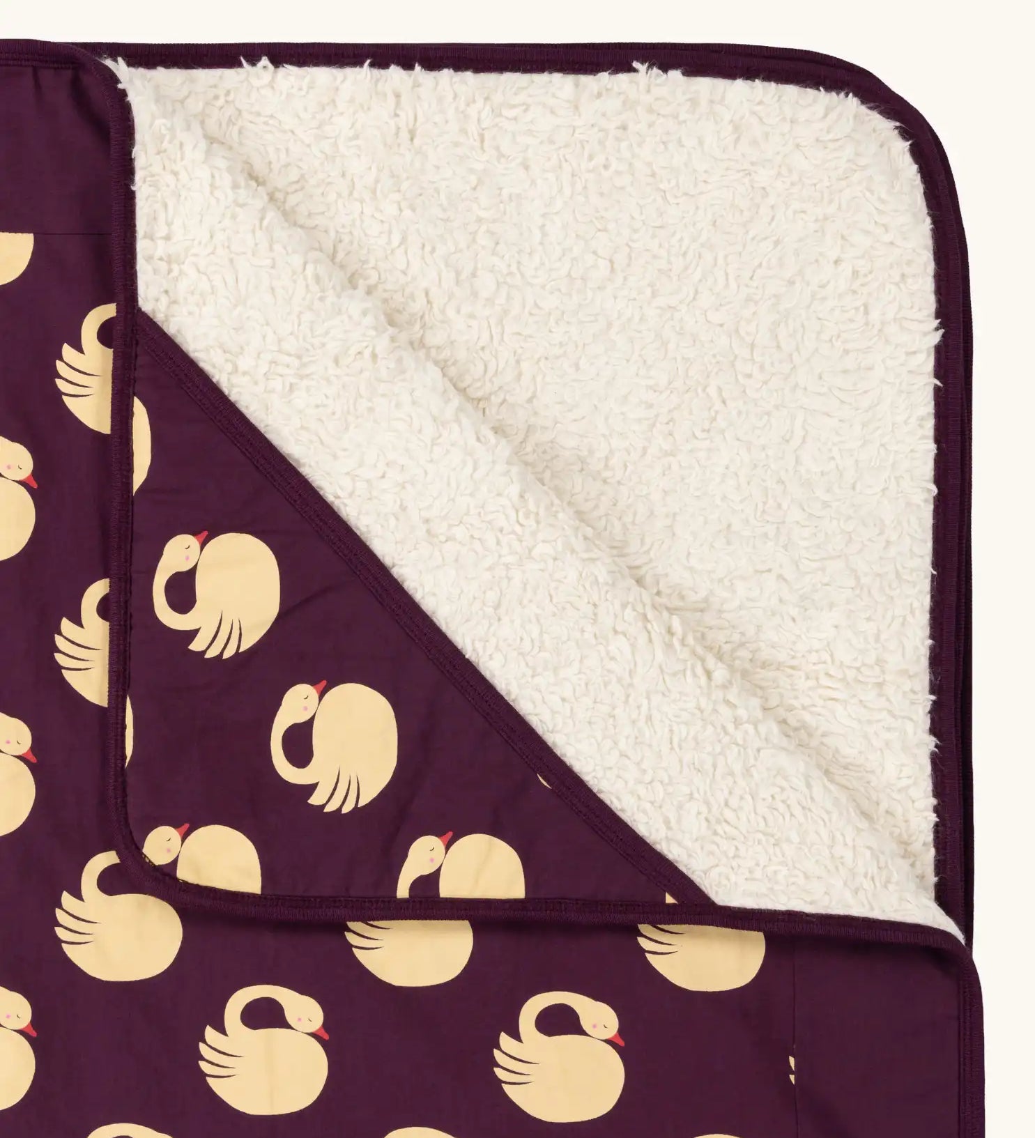 Close up of the Little Green Radicals swans organic sherpa hooded baby blanket.