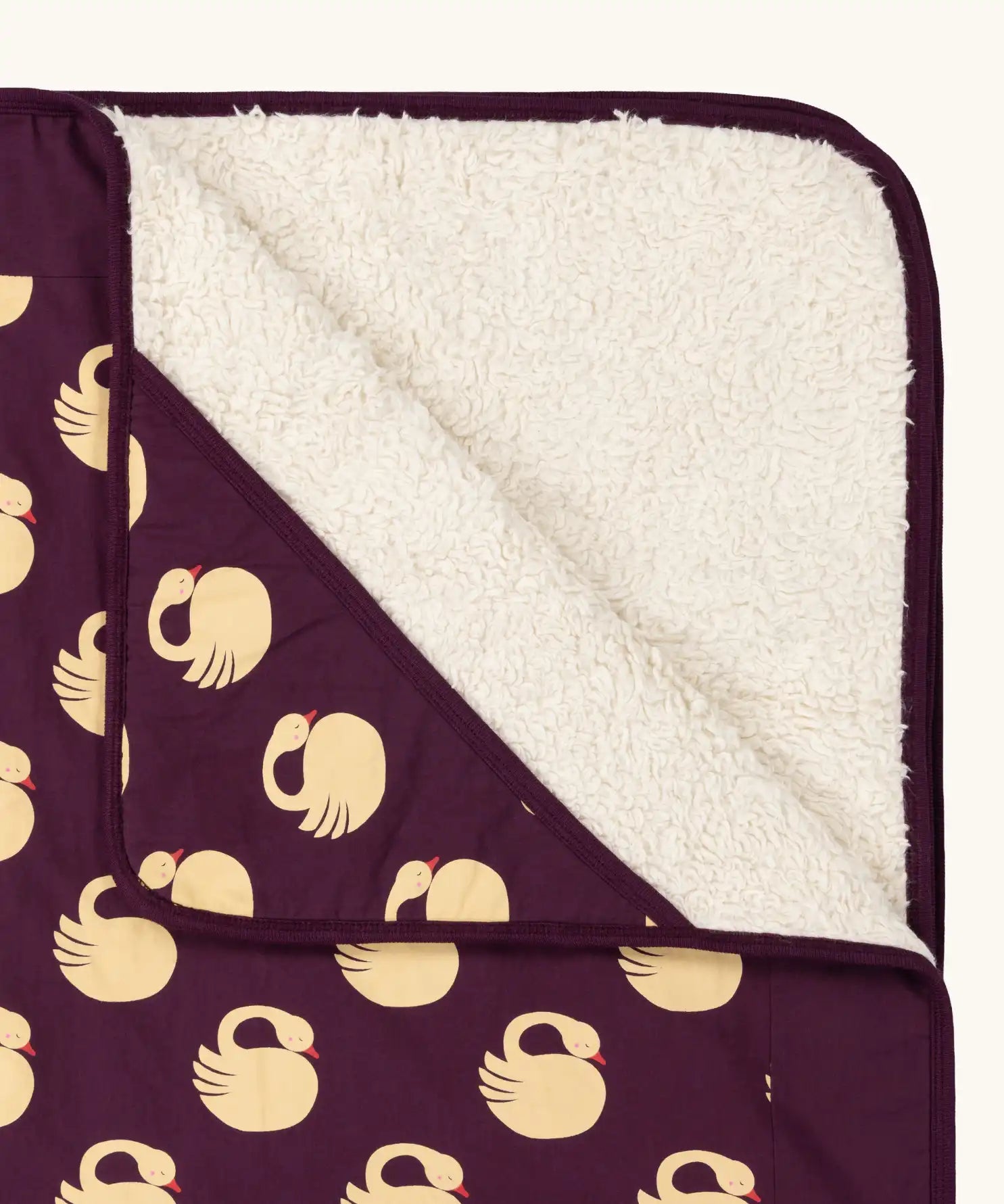 Close up of the Little Green Radicals swans organic sherpa hooded baby blanket.