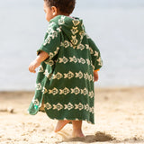 Back of a child wearing the Little Green Radicals swimming fish organic cotton hooded towel poncho. Cream fish pattern on a green background.