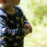 A close up of a child wearing the Little Green Radicals Kids' Organic Top and Joggers Playset with sleeping sheep print. Little green Radicals have a wide range of organic cotton, Fairtrade children's clothing an outerwear available here at Babipur.
