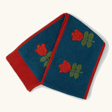 Little Green Radicals tulips knitted blue scarf. Blue scarf with red tulips and red trim.