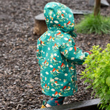 Back of a child wearing the Little Green Radicals turquoise birds recycled waterproof kids raincoat with the hood up. Repeat pattern featuring bird on blossom branches.