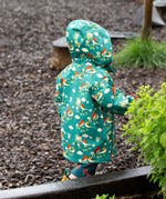 Back of a child wearing the Little Green Radicals turquoise birds recycled waterproof kids raincoat with the hood up. Repeat pattern featuring bird on blossom branches.