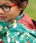 Close up of the mesh lining on the hood of the Little Green Radicals turquoise birds recycled waterproof kids raincoat. Repeat pattern featuring bird on blossom branches.