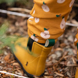 Close up of the bottoms of the Little Green Radicals yellow gold comfy organic cotton kids joggers being worn with yellow wellington boots.
