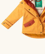 Close up of the pockets on the front of the Little Green Radicals  yellow gold recycled waterproof 3 in 1 coat. Yellow gold waterproof coat with a removable fleece layer inside. 