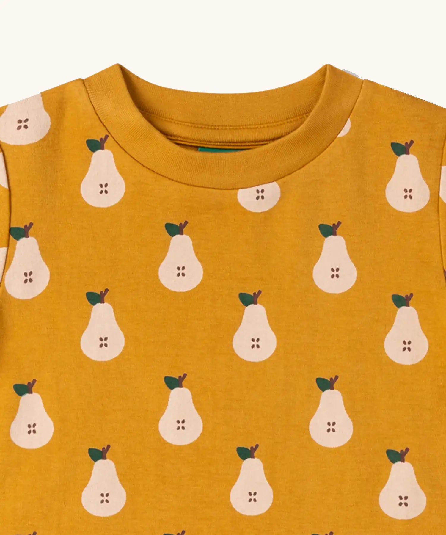 Close up of the neckline on the Little Green Radicals yellow gold summer pears short sleeve organic cotton t-shirt. 