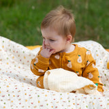 Little Green Radicals summer pears repeat print zip organic cotton footed babygrow being worn. 