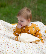 Little Green Radicals summer pears repeat print zip organic cotton footed babygrow being worn. 