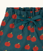 Close up of the waistband and tie on the Little Green Radicals blue kids organic cotton shorts with repeat apple print all over. 